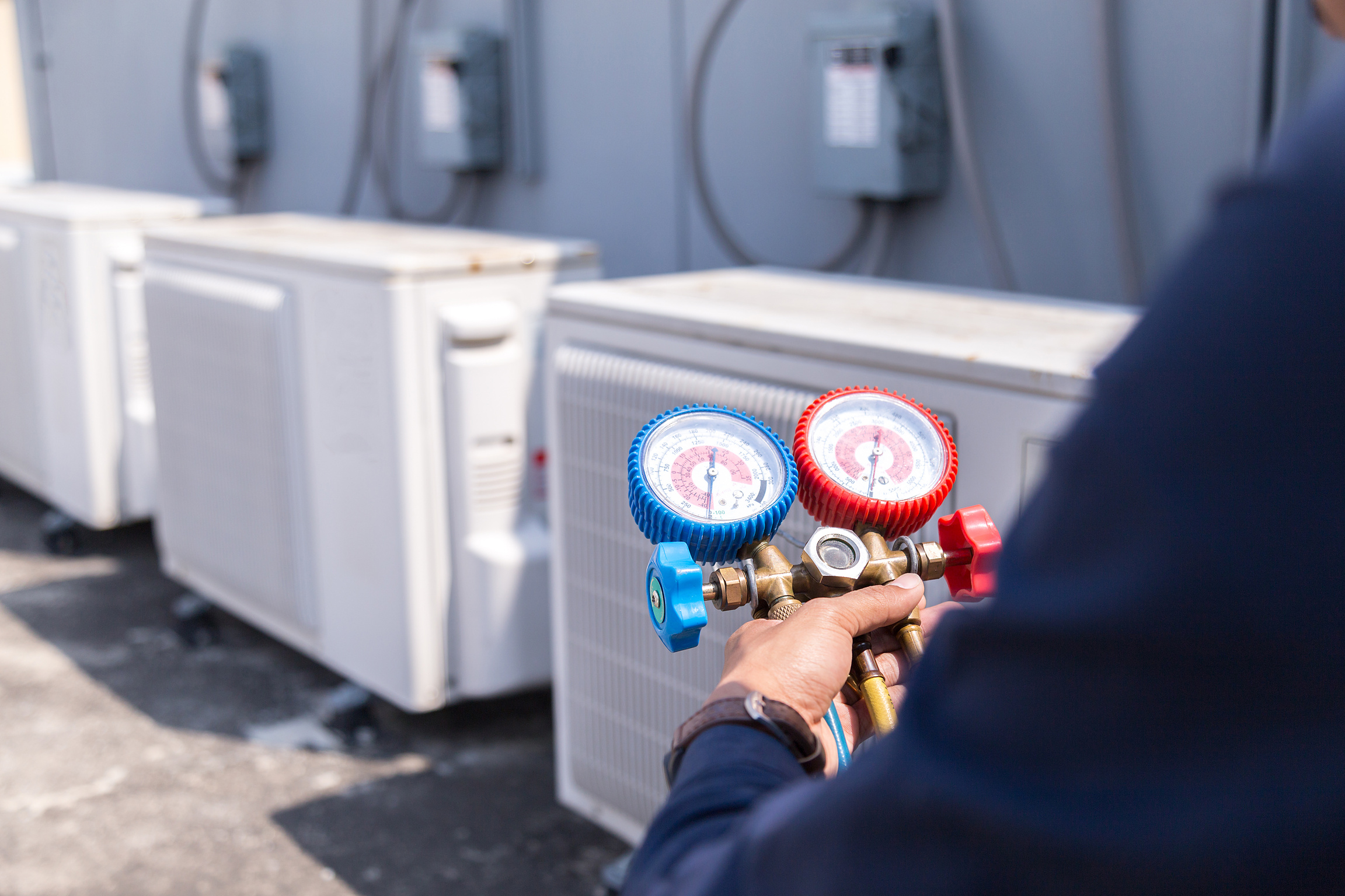 Technician is checking air conditioner ,measuring equipment for filling air conditioners.